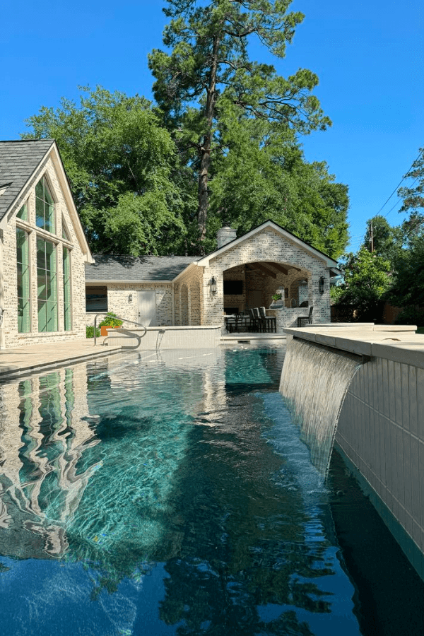 Custom freeform pool with spa and travertine deck