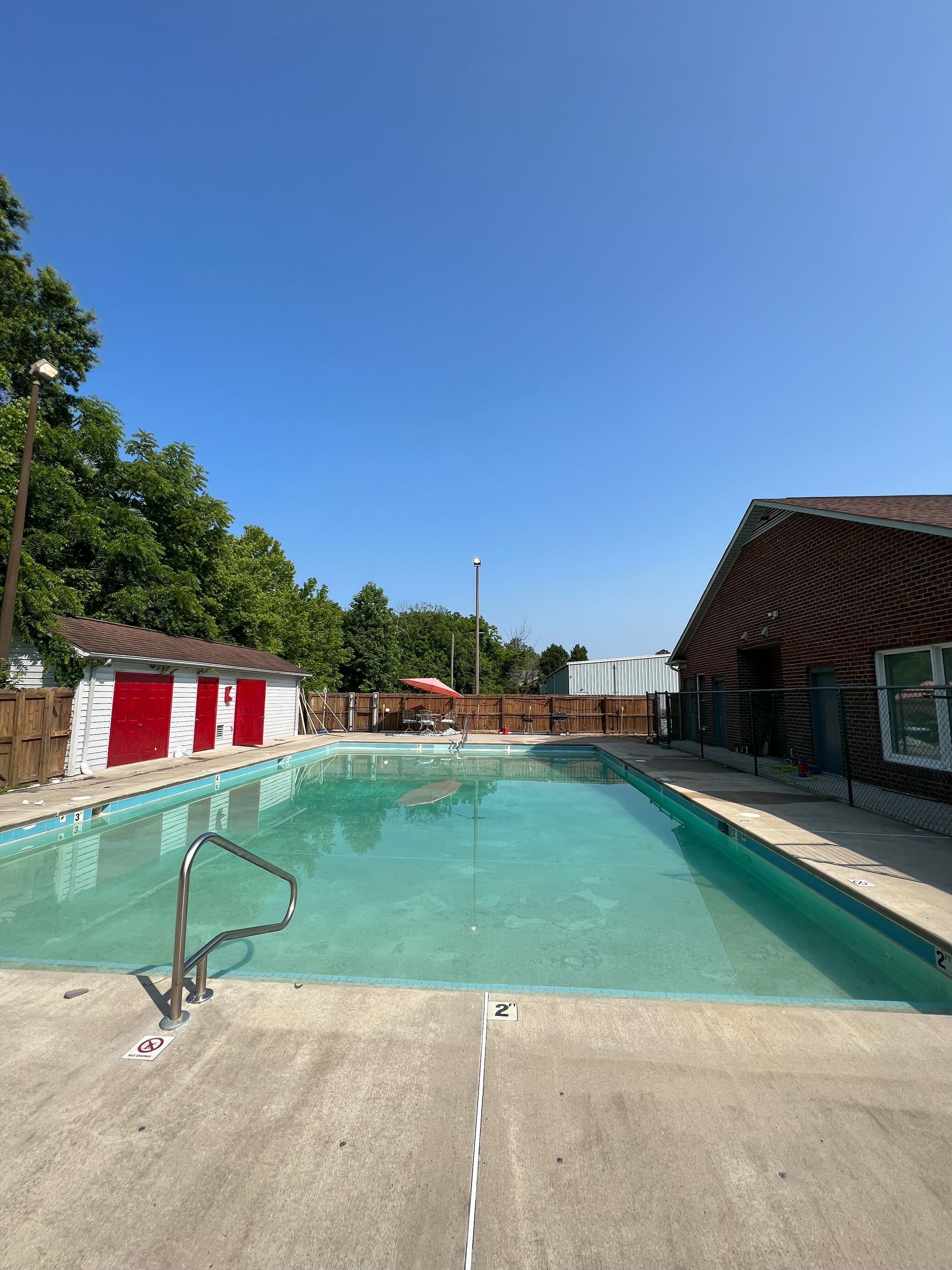 Clear blue backyard pool after algae treatment